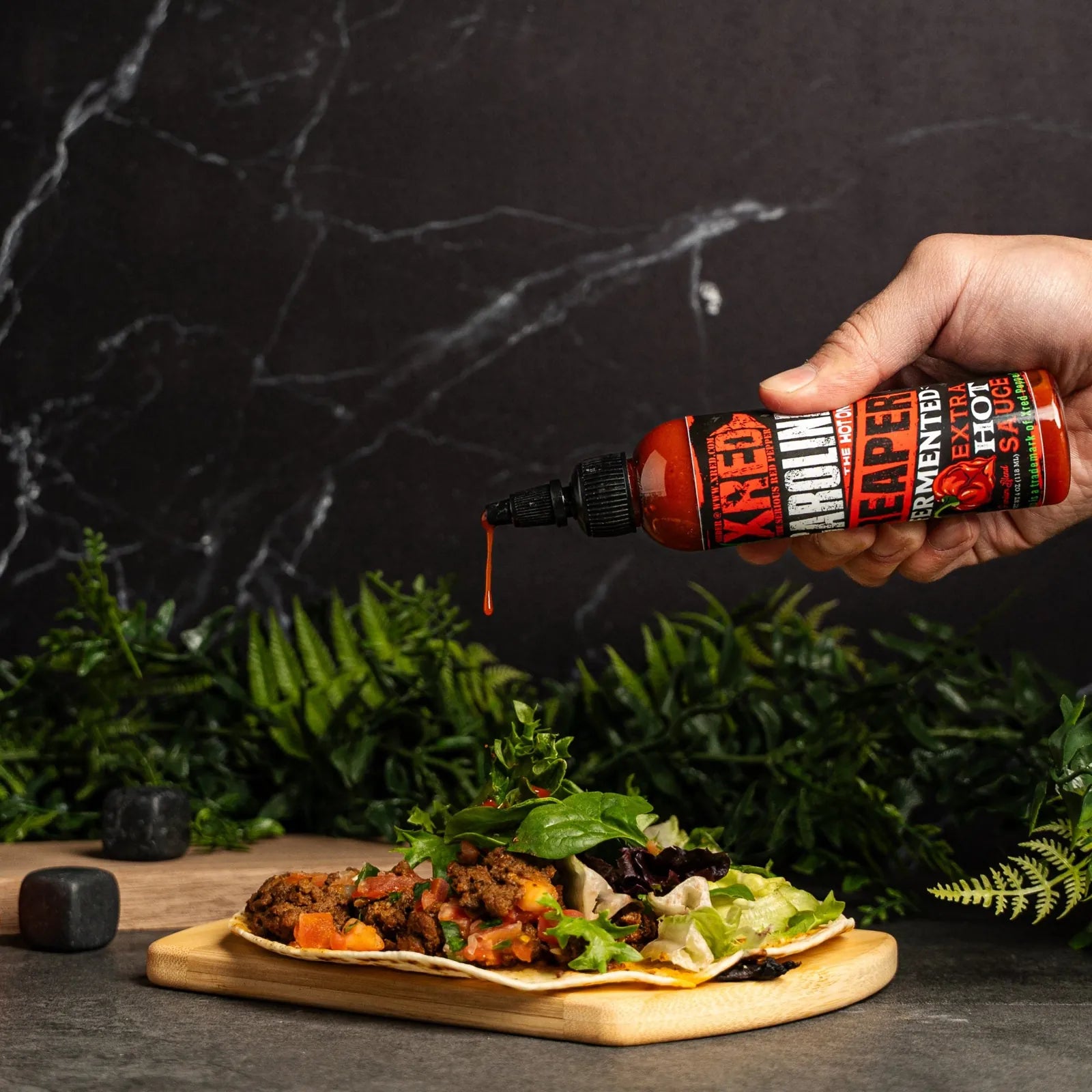 Pouring Xred Carolina Reaper onto tacos